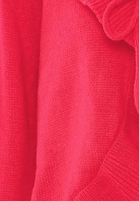 Maglione rosso lavorato a maglia con una texture liscia, caratterizzato da un colletto a coste e un accento decorativo a fiocco sulla spalla.
