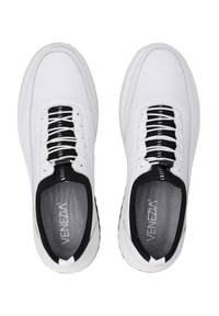 White athletic shoes with a mesh upper, black accents, and lace-up design. Features a cushioned insole and textured outsole.