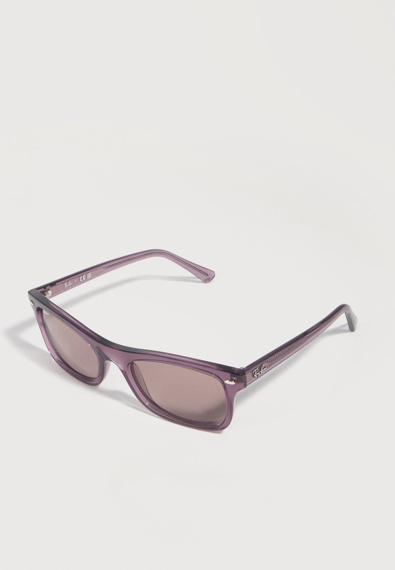 Μωβ διαφανή ορθογώνια γυαλιά ηλίου με σκουρόχρωμους φακούς και λογότυπο Ray-Ban στον βραχίονα, εμφανισμένα σε λευκό φόντο με κλίση.