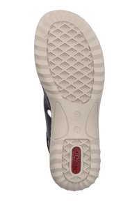 Sandal noir avec une semelle en caoutchouc texturé beige, présentant des détails découpés et un logo rouge sur le talon. Taille 37 indiquée.