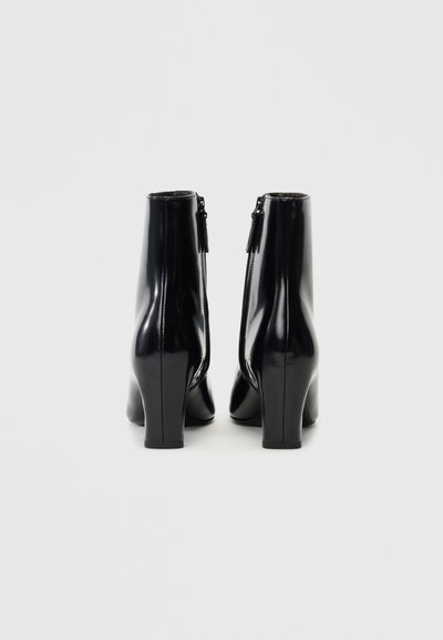 Black patent leather ankle boots with a tapered shape, medium block heels, and side zippers for easy wear. Smooth, reflective surface.