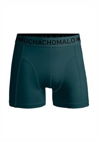 Tamsiai žalia šortai su elastingu juosmeniu, ant kurio yra "MUCHACHO" logotipas. Lygi tekstūra ir prisitaikantis dizainas su matomomis siūlių detalėmis.