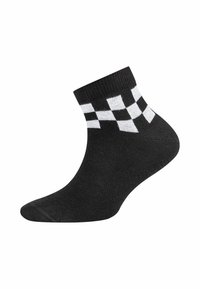 Schwarze Knöchelsocke mit einem weiß-schwarz karierten Muster am Bündchen, dargestellt vor weißem Hintergrund.