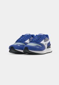 Blue athletic sneakers with suede and mesh upper, white accents, grey detailing, lace-up design, and textured black rubber outsole.