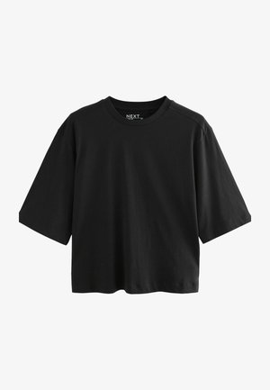 T-shirt nera a maniche corte realizzata in cotone. Presenta un classico scollo rotondo e una vestibilità rilassata. Tessuto morbido senza motivi prominenti.