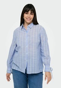 Light blue striped button-up shirt with long sleeves, featuring a collar and tied cuffs, made from lightweight fabric.