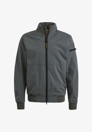 Siva jakna z visokim ovratnikom, celotnim zadrgo in rebrastimi manšeti. Ima žep z zadrgo na roki in gladko teksturo.