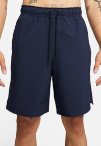 Navy blue swim shorts made of soft, lightweight fabric. Features an elastic waistband with a drawstring, and side pockets for convenience.
