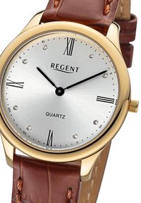 Montre à quartz avec un cadran argenté, boîtier doré, bracelet en cuir marron, chiffres romains et marqueurs en cristal décoratifs.