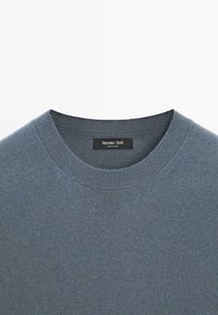 Dark blue knitted sweater with a round neckline. Features ribbed cuffs and hem. Label reads "Massimo Dutti." Soft texture.