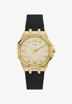 Zegarek w złotym odcieniu z teksturowanym czarnym paskiem, ośmiokątną kopertą, pierścieniem zdobionym kryształami i tarczą wysadzaną kamieniami z dużymi znacznikami godzin.