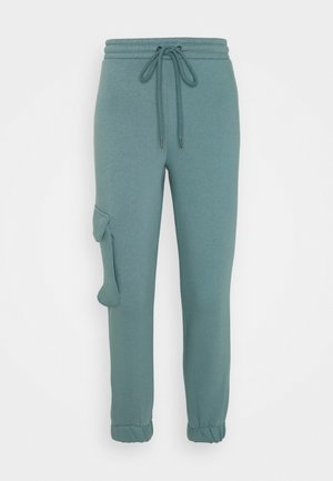 Joggingbroek in tealgroen met elastische tailleband, trekkoord, zijvak met klep en elastische boorden.