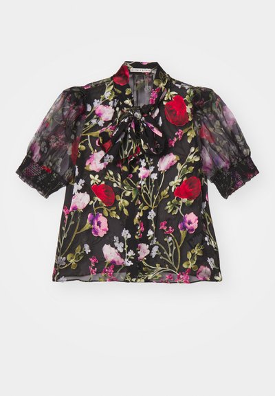 Blouse noire transparente avec un motif floral. Comprend des manches bouffantes, un nœud au cou et des accents en dentelle sur les poignets.