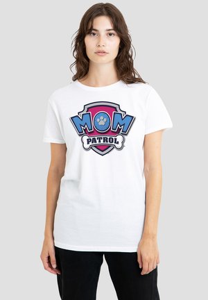 White cotton t-shirt featuring a colorful "MOM PATROL" graphic with a paw print on a shield, set against a neutral gray background.