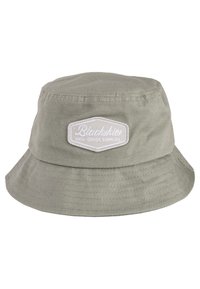 Olivgrön bucket hat i bomull, med en bred brätte och en vit lapp med texten "Blackskies High Grade Supplies." Strukturerad tyg.