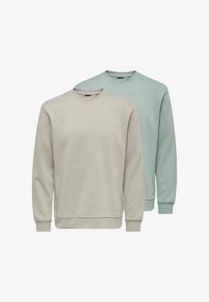 Two plain crewneck sweatshirts, one light beige in front and one muted green behind, both with long sleeves and ribbed cuffs.