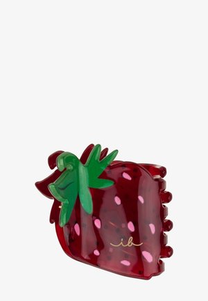 Pince à cheveux en plastique rouge, en forme et couleur de fraise, avec un détail de feuille verte et de petites taches roses ressemblant à des graines.