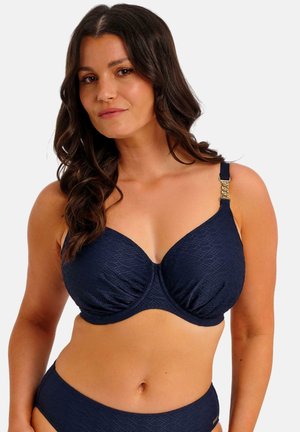 Marineblauwe bikinitop met beugels, gestructureerde stof, geplooide details en verstelbare bandjes met gouden accenten.