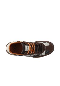 Brown suede and fabric sneaker with white accents, black details, and orange laces. Designed with a rounded toe and a padded collar.