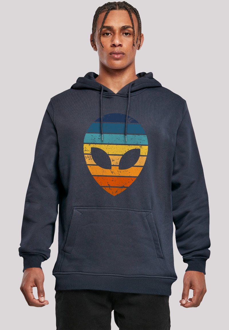 Navy hooded sweatshirt made of cotton, featuring a textured, gradient alien graphic in blue, orange, and yellow across the front.