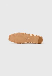 Strappy sandal with a textured, striped pattern in orange and beige, featuring a smooth sole and minimalist design without visible hardware.