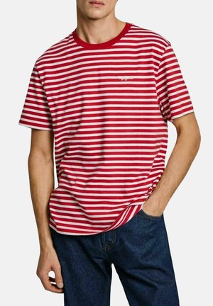 Red and white striped short-sleeve T-shirt with a ribbed neckline and a relaxed fit, paired with dark denim jeans.