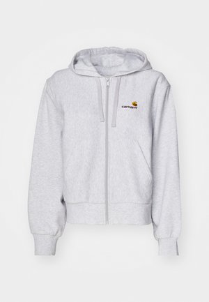 Haut de survêtement zippé gris clair en tissu doux, avec une coupe décontractée, des poches avant et un petit logo brodé sur la poitrine gauche.