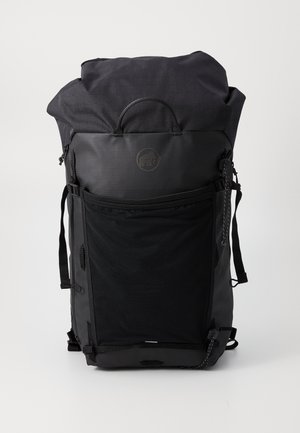 Black roll-top backpack with textured fabric, external zip pocket, adjustable straps, and a logo patch on the front.