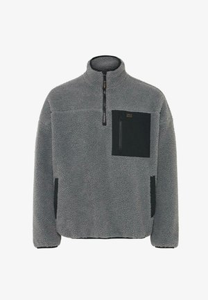 Sudadera de forro polar en gris claro con un tejido texturizado, cierre de media cremallera y bolsillos negros en el pecho y los lados.