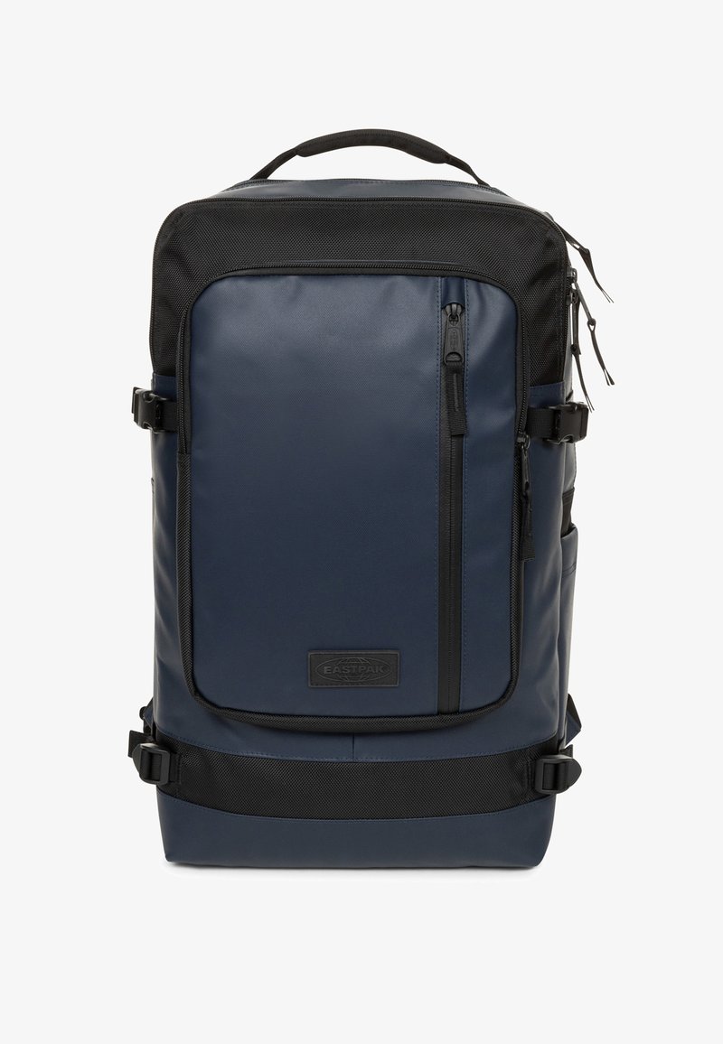 Tasje in marineblauw, gemaakt van duurzaam materiaal. Bevat zwarte accenten, een voorzak met rits en verstelbare schouderbanden voor een veilige draagervaring.