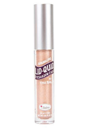 Transparent tube of sparkling liquid eyeshadow with a coppery-gold hue, silver cap, and black label. Contains 4.5 mL of product.