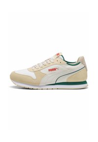Beige and white sneakers made of suede and textile. Features green accents, a textured sole, and red logo on the side. Traditional lace-up design.