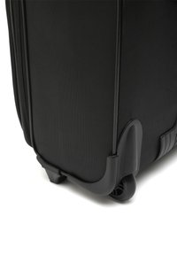 Black hard-shell suitcase with textured fabric, smooth zipper, and durable wheels for easy mobility. Features a reinforced corner design.