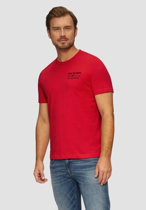 Red cotton t-shirt with short sleeves, featuring black text that says “FISH ‘N CHIPS” and contact details printed on the front.
