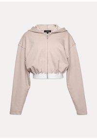 Zastrihnutá mikina na zips v svetlom béžovom materiáli, s kapucňou, širokými rukávmi a bielym elastickým pásom s logom. Hladká textúra.