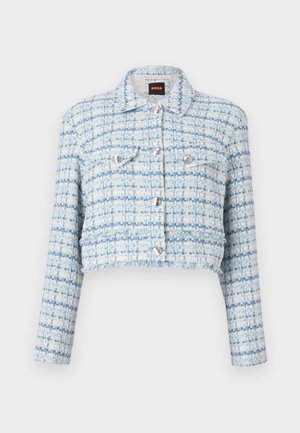 Kraftig jacka i ljusblå tweed med vita trådar. Har silverknappar och två bröstfickor. Texturerad och strukturerad design.