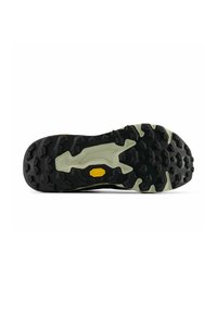 Semelle de chaussure en caoutchouc Vibram noire et beige avec des crampons profonds et multidirectionnels pour une meilleure adhérence et traction.
