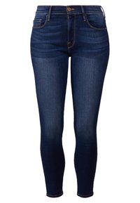 Jeans ajustados azul oscuro en material de mezclilla. Las características incluyen un cierre frontal con botón, presillas para cinturón y un desvanecimiento mínimo. Corte slim a lo largo de las piernas.