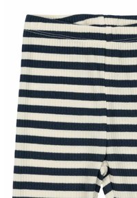 Randiga tights i marinblått och krämfärgat, tillverkade av ribbad tyg. Har en elastisk midja och vertikala ränder i varierande bredder.