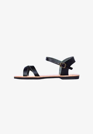 Black leather sandals featuring two crossed straps, an adjustable ankle strap with buckle, and a flat brown sole.