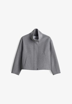 Gray cropped wool jacket with a high collar, front snap closure, and side pockets. Features a clean, minimal design with a textured fabric.