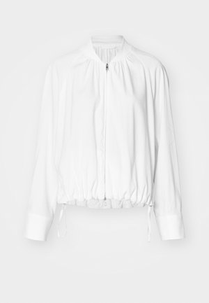 White, lightweight bomber jacket with a zip front, elasticized hem, and cuffs. Features a gathered design at shoulders and adjustable drawstrings.