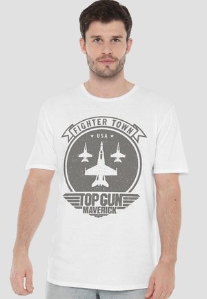 White cotton t-shirt featuring a graphic print with military aircraft icons, "Fighter Town" and "Top Gun Maverick" text in gray.