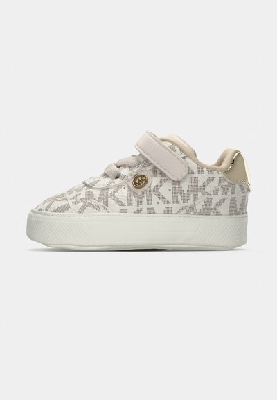 White sneakers with a textured pattern, featuring a Velcro strap, gold hardware accent, and a rubber sole. Soft fabric upper and rounded shape.