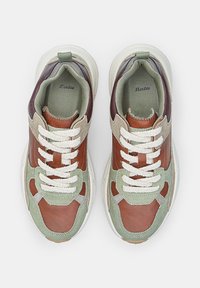 Pair of leather and suede sneakers in brown, green, and beige with white laces, viewed from above on a white background.
