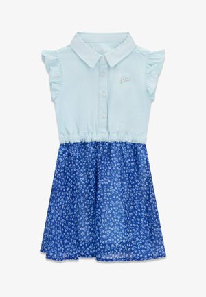 Haljina bez rukava s ovratnikom, svijetloplavi gornji dio s naboranim rukavima i gumbima, te plava suknja s malim bijelim cvjetnim uzorkom.