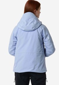 Giacca impermeabile blu chiaro con cappuccio, caratterizzata da una texture liscia, un taglio dritto e un logo sul braccio sinistro.