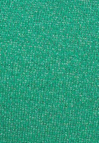 Tessuto tricot verde con texture caratterizzato da un filo metallico che crea un effetto luccicante, con un motivo a coste uniforme.