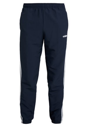 Marineblauwe Adidas trainingsbroek met elastische tailleband en boorden, witte zijstrepen, en klein wit Adidas-logo op de voorkant van de rechter dij.