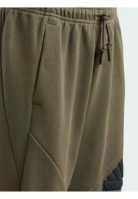 adidas Performance FUTURE ICON - Pantalones deportivos - olive strata   black